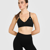 EnhanceLift™ Seamless Strappy Sports Bra with White Logo | Black