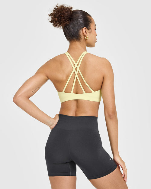 EasyLift™ High Neck Sports Bra with White Logo | Pastel Yellow