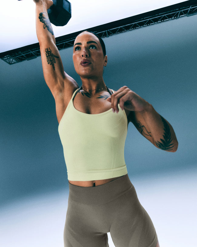EnhanceLift™ Seamless Strappy Racer Vest with Built in Bra Shelf with Grey Logo | Pastel Yellow