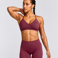 EnhanceLift™ Seamless Strappy Sports Bra with Gray Logo | Burnt Maroon Red
