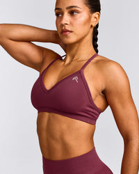 EnhanceLift™ Seamless Strappy Sports Bra with Gray Logo | Burnt Maroon Red