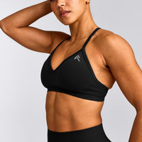 EnhanceLift™ Seamless Strappy Sports Bra with Gray Logo | Black
