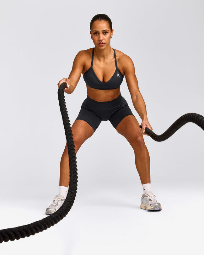 EnhanceLift™ Seamless Strappy Sports Bra with Gray Logo | Coal