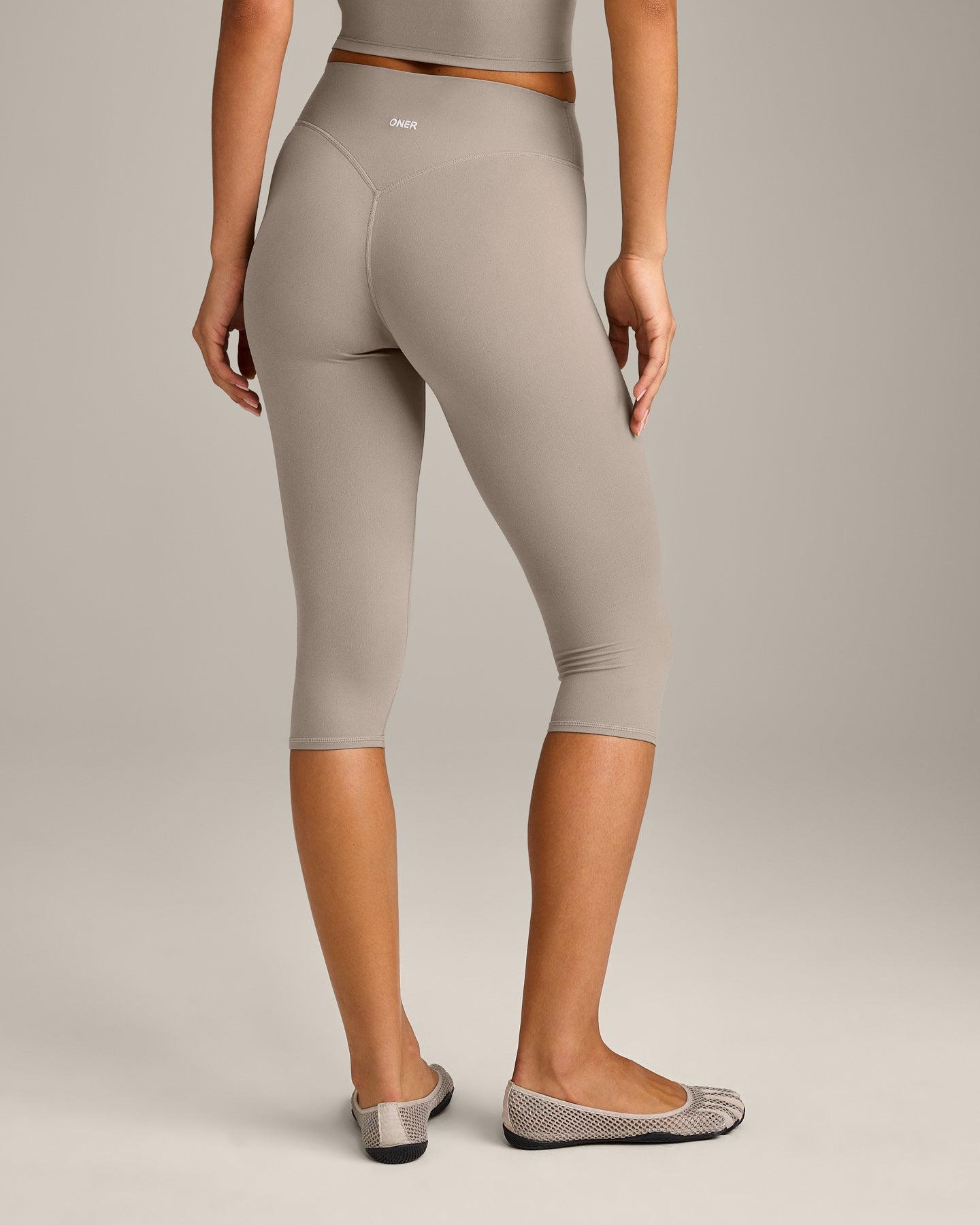 SoftMotion™ High Waisted Capri Leggings with White Logo | Warm Sand