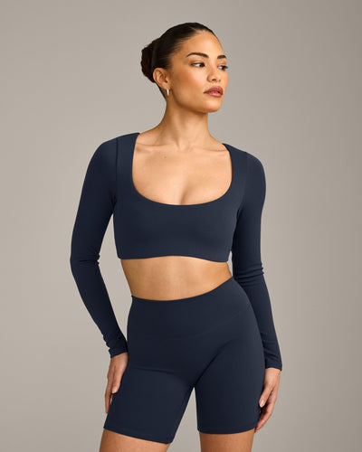 SoftMotion™ Scoop Neck Long Sleeve Crop Top with Built in Bra Shelf with Grey Logo | True Blue