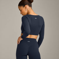 SoftMotion™ Scoop Neck Long Sleeve Crop Top with Built in Bra Shelf with Grey Logo | True Blue