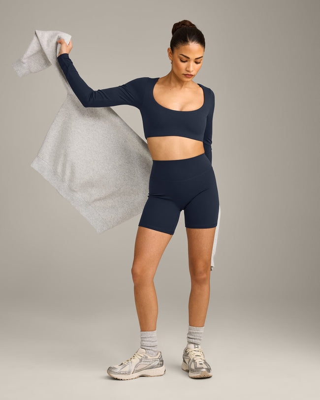 SoftMotion™ Scoop Neck Long Sleeve Crop Top with Built in Bra Shelf with Grey Logo | True Blue