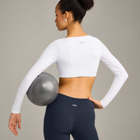 SoftMotion™ Scoop Neck Long Sleeve Crop Top with Built in Bra Shelf with Grey Logo | White