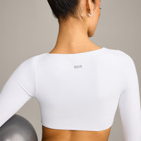 SoftMotion™ Scoop Neck Long Sleeve Crop Top with Built in Bra Shelf with Grey Logo | White