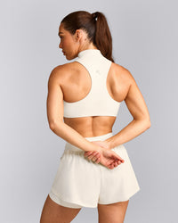 EasyLift™ Zip High Neck Sports Bra with Gray Logo | Marshmallow White
