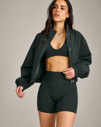 SoftMotion™ Minimal Halter Neck Bralette with Grey Logo | Emerald Noir