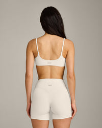 SoftMotion™ Strappy Sports Bra with Grey Logo | Marshmallow White
