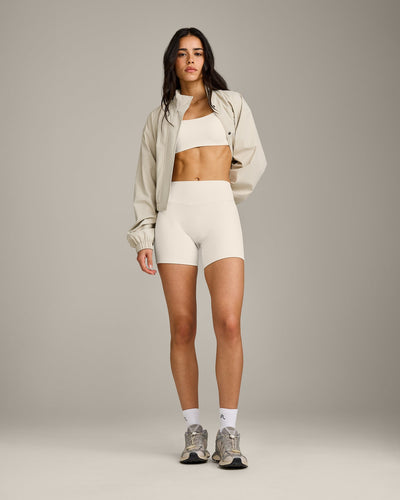 SoftMotion™ Strappy Sports Bra with Grey Logo | Marshmallow White