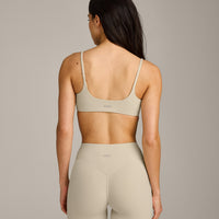 SoftMotion™ Strappy Sports Bra with Grey Logo | Oatmeal