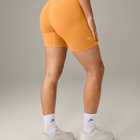 EffortlessLift™ Seamless Mid Rise Shorts with Grey Logo | Powdered Orange