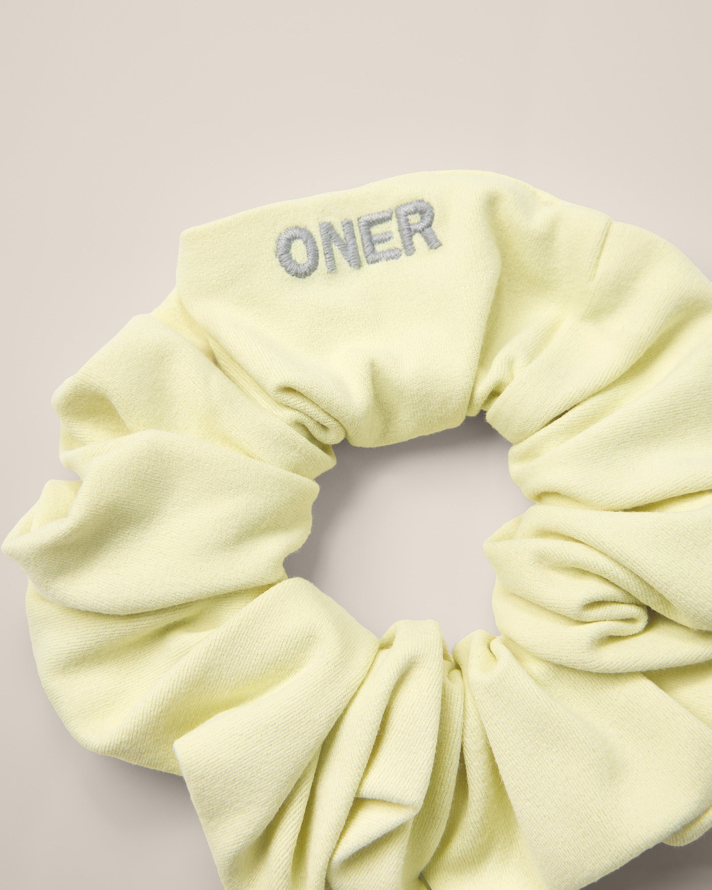 SoftMotion™ Scrunchie with Grey Logo | Pastel Yellow