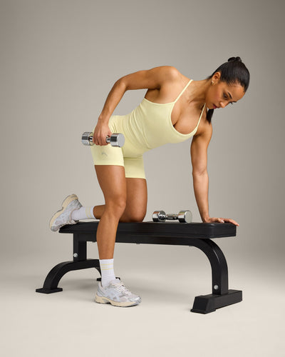 EnhanceLift™ Seamless Strappy Racer Vest with Built in Bra Shelf with Grey Logo | Pastel Yellow