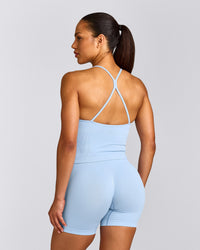EnhanceLift™ Seamless Strappy Racer Vest with Built in Bra Shelf with Grey Logo | Powdered Blue