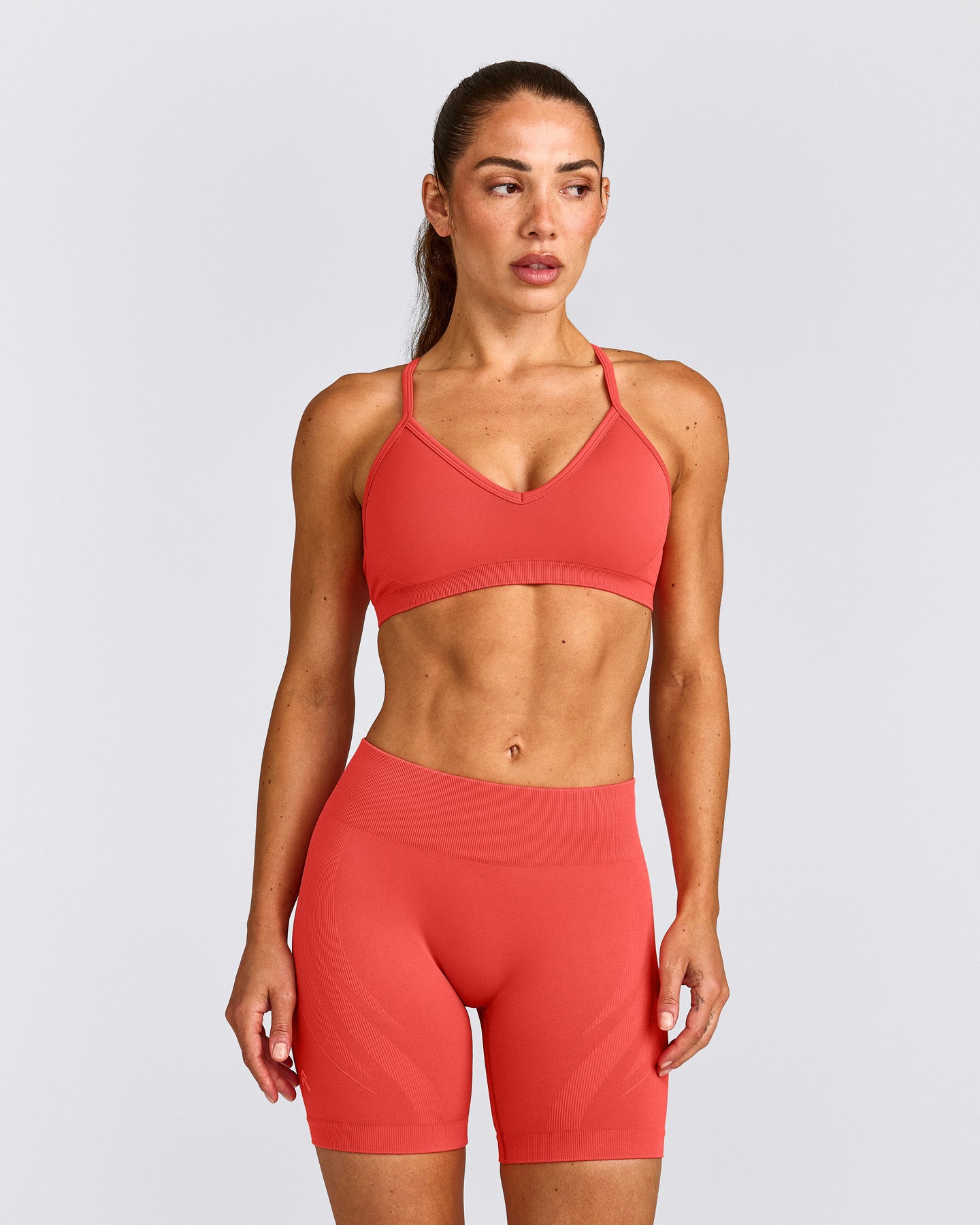 EnhanceLift™ Seamless Strappy Sports Bra with Grey Logo | Dark Charged Coral