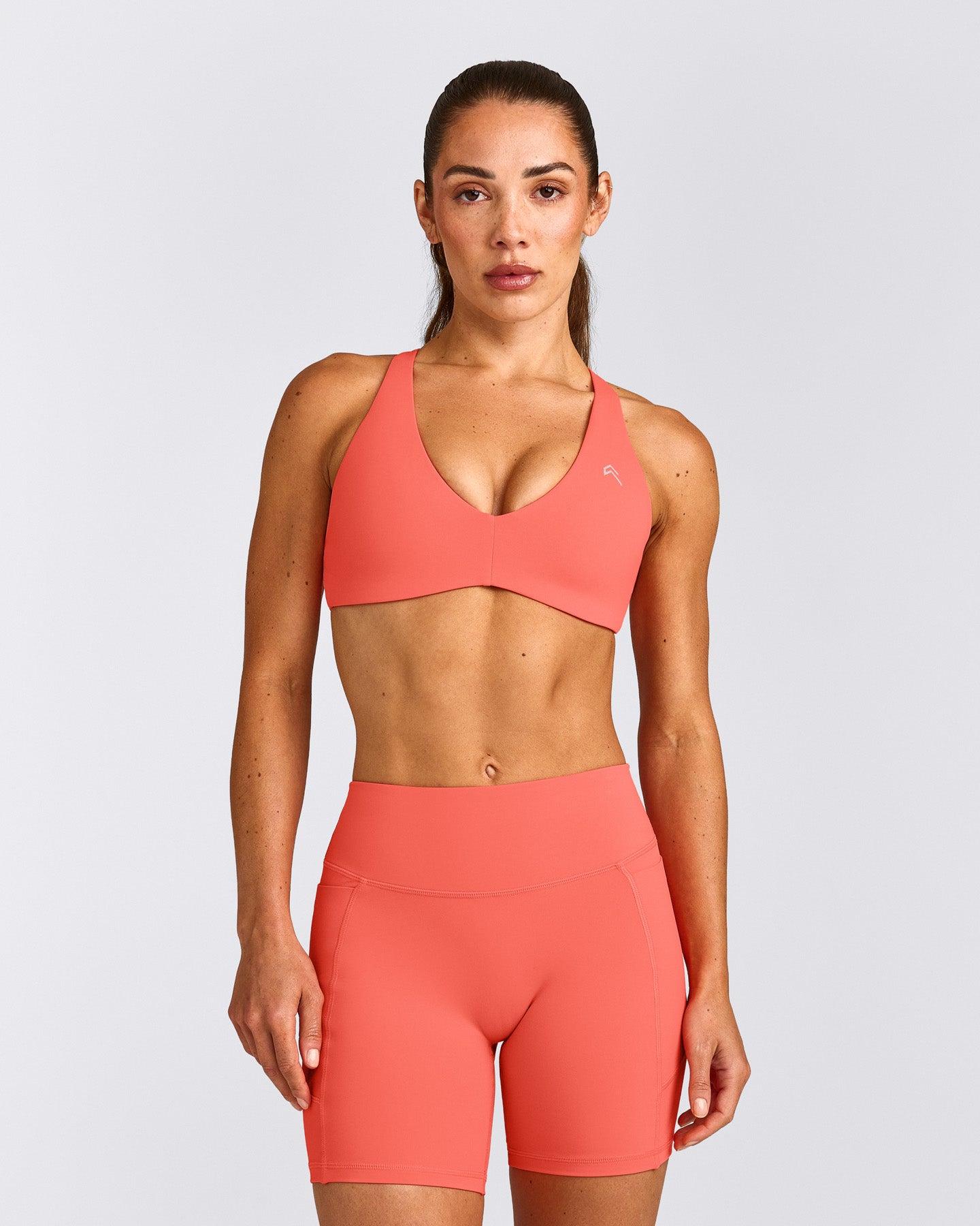 UnifiedMove™ Cross Back Sports Bra with Reflective Logo | Light Charged Coral