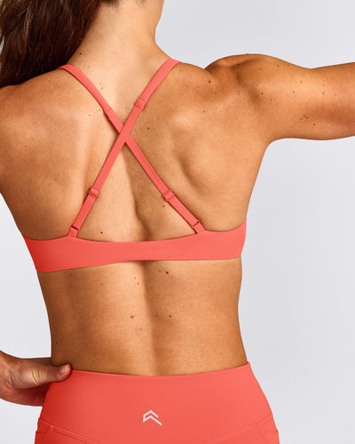 UnifiedMove™ Cross Back Sports Bra with Reflective Logo | Light Charged Coral