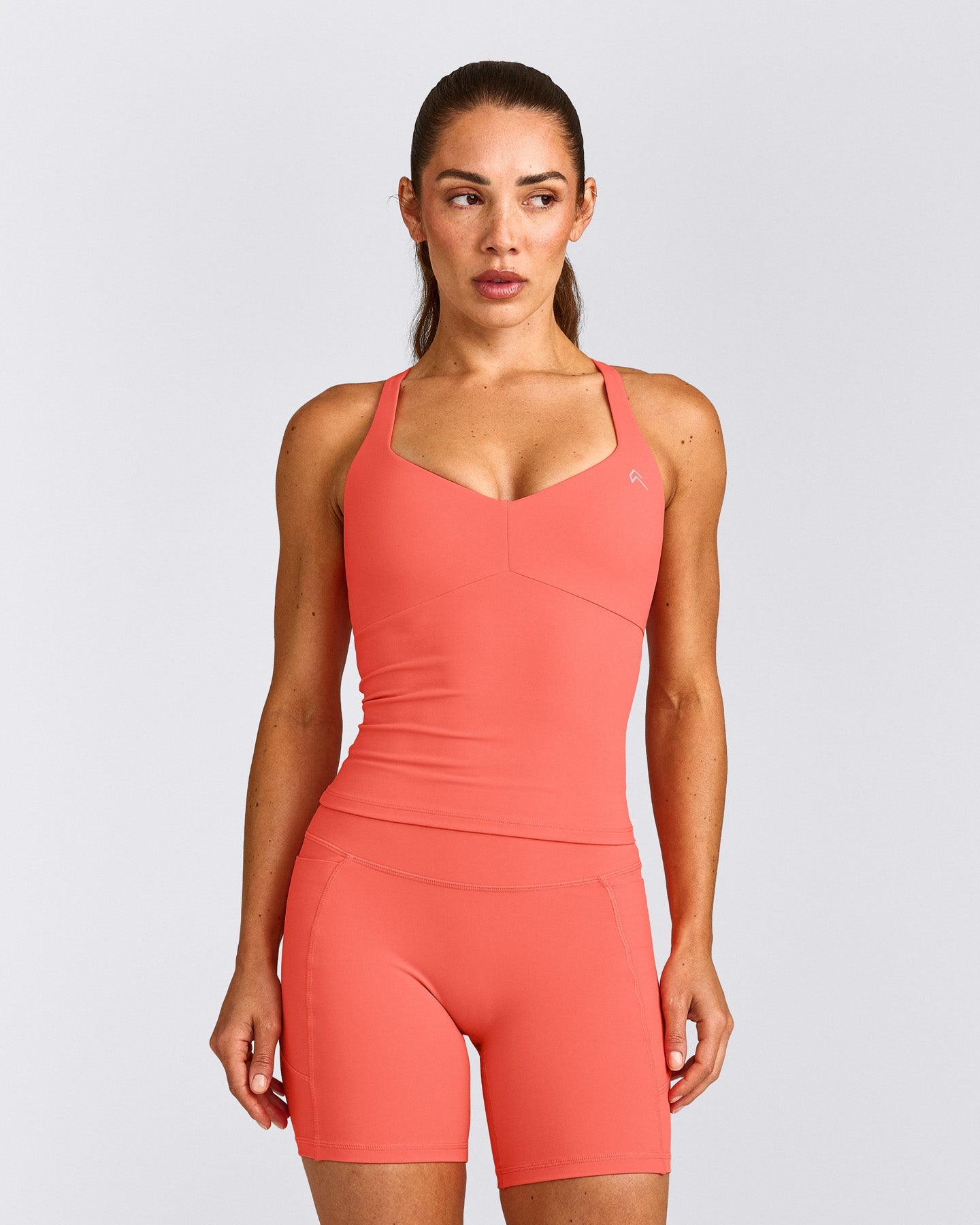 UnifiedMove™ T Back Mid Vest with Built in Bra Shelf with Reflective Logo | Light Charged Coral