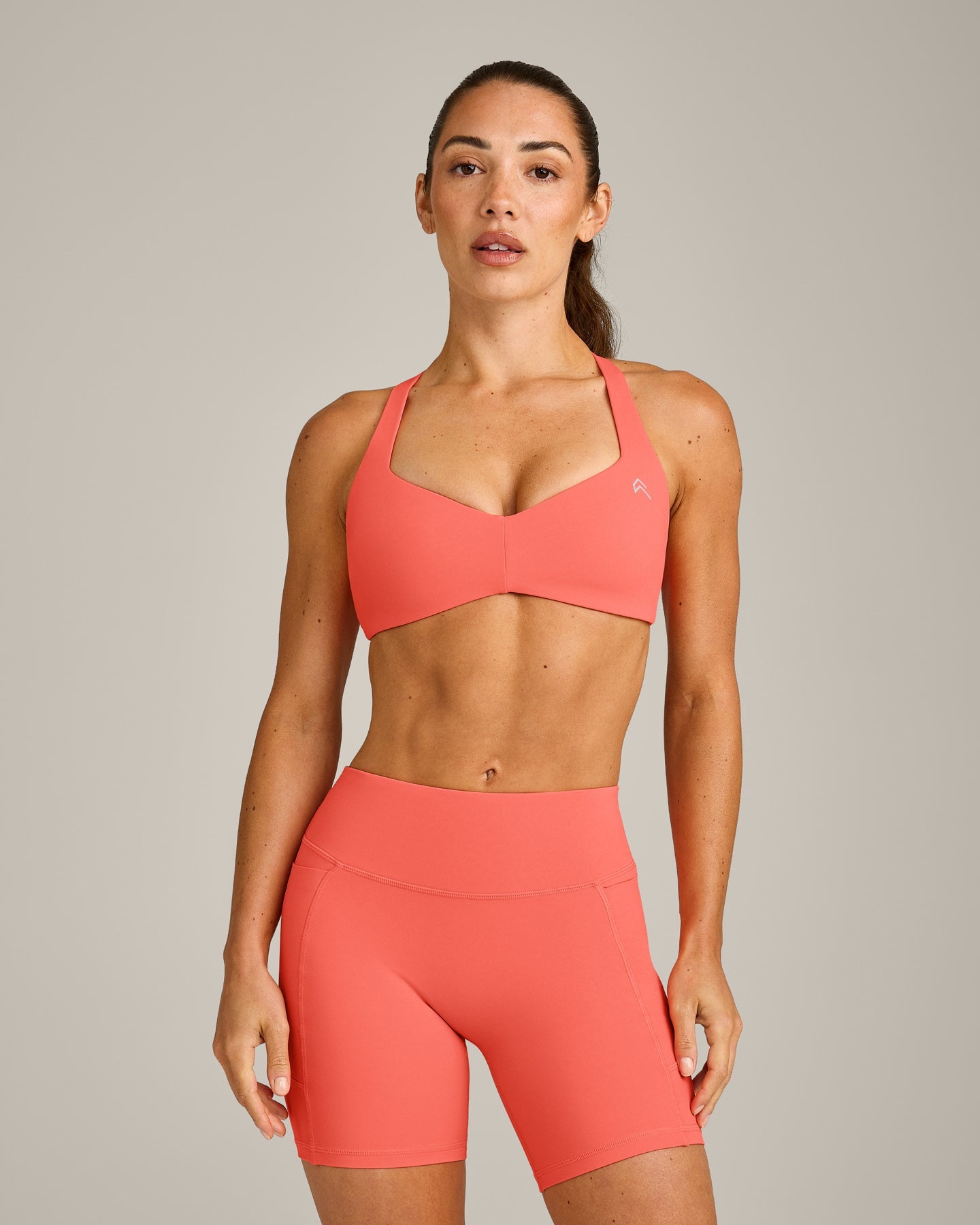 UnifiedMove™ T Back Minimal Bralette with Reflective Logo | Light Charged Coral