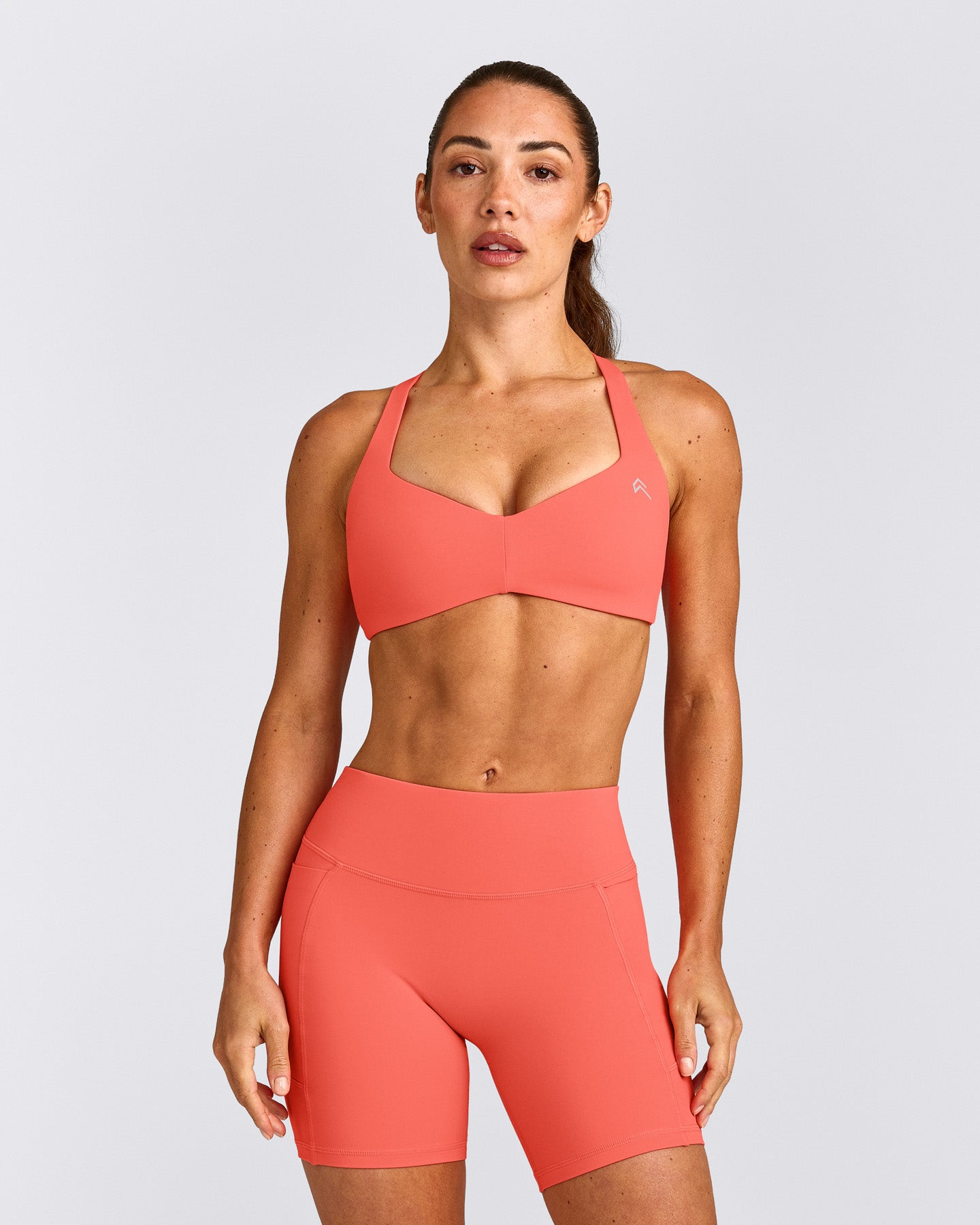 UnifiedMove™ T Back Minimal Bralette with Reflective Logo | Light Charged Coral
