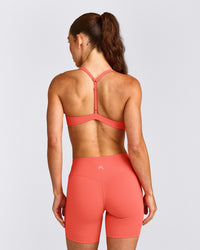 UnifiedMove™ T Back Minimal Bralette with Reflective Logo | Light Charged Coral