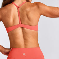 UnifiedMove™ T Back Minimal Bralette with Reflective Logo | Light Charged Coral