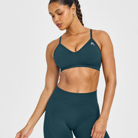 EnhanceLift™ Seamless Strappy Sports Bra with White Logo | Washed Oil Blue