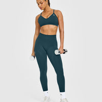 EnhanceLift™ Seamless Strappy Sports Bra with White Logo | Washed Oil Blue