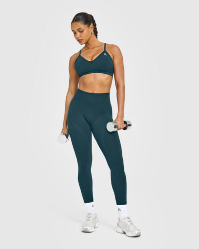 EnhanceLift™ Seamless Strappy Sports Bra with White Logo | Washed Oil Blue