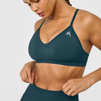 EnhanceLift™ Seamless Strappy Sports Bra with White Logo | Washed Oil Blue