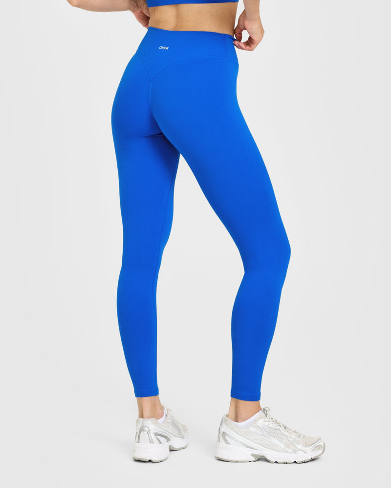 SoftMotion™ High Waisted Leggings with White Logo in Light Cobalt